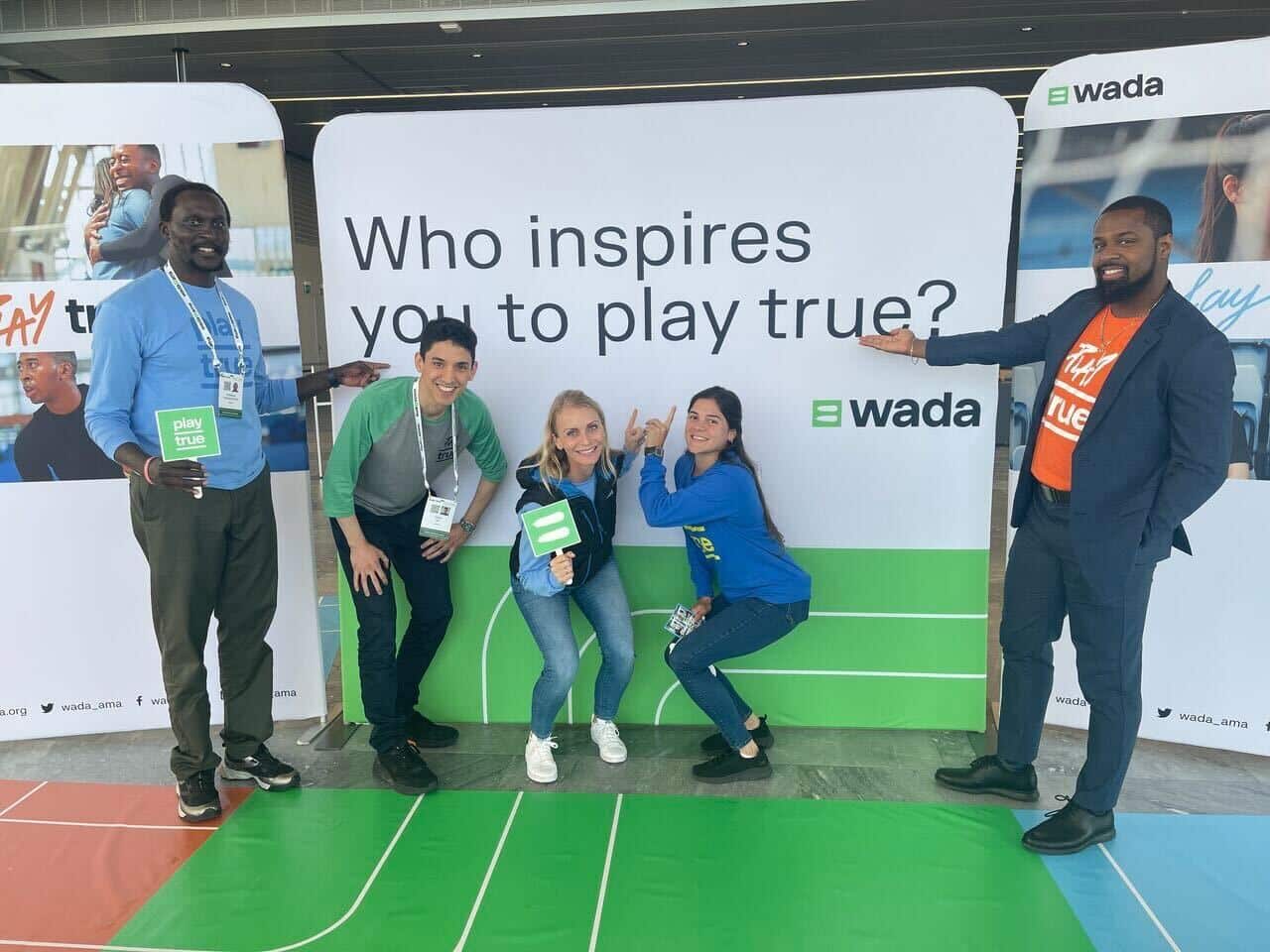 Adriana Escobar with colleagues in front of WADA standing display